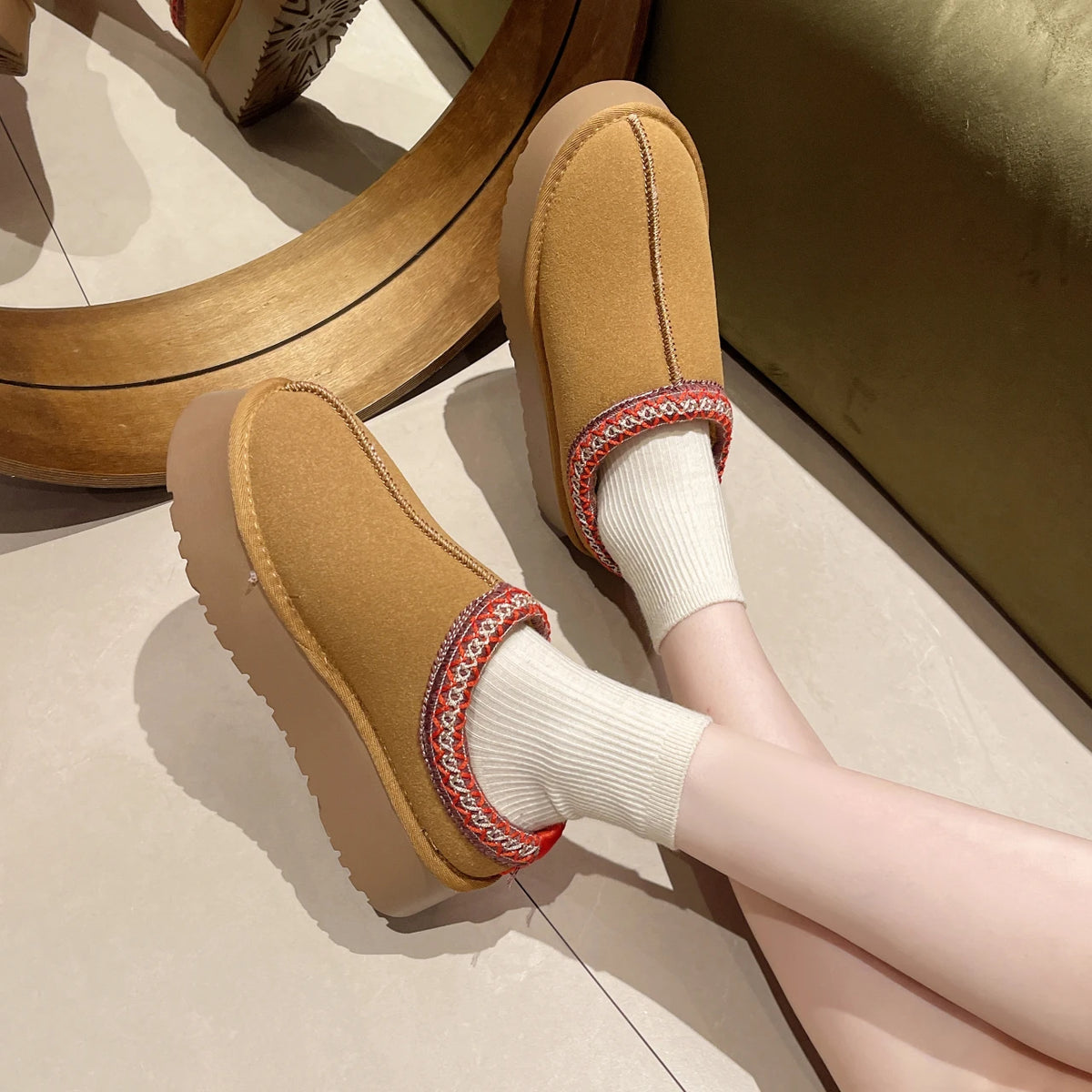 Tan platform slipper worn with a white sock